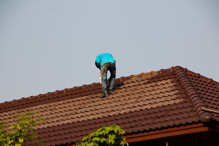 Roofer Painting a Tile Roof