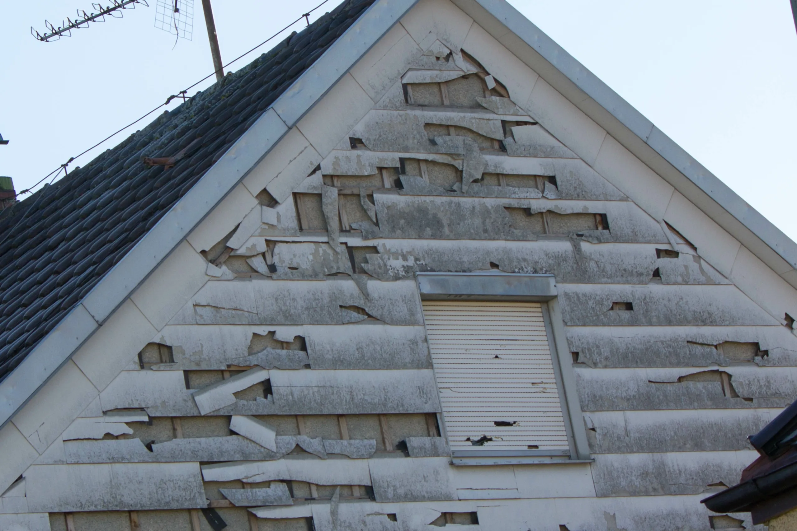 Home with Severe hail damage to siding