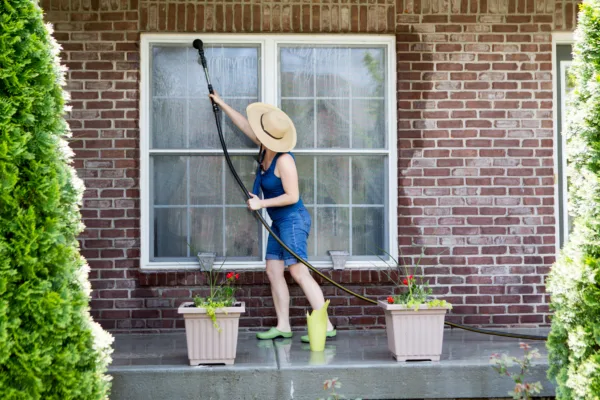 Woman doing her spring cleaning and washing windows