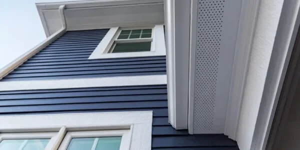 Image of navy James Hardie fiber cement siding and overhang.