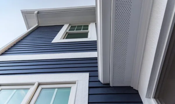 Image of navy home siding and overhang.