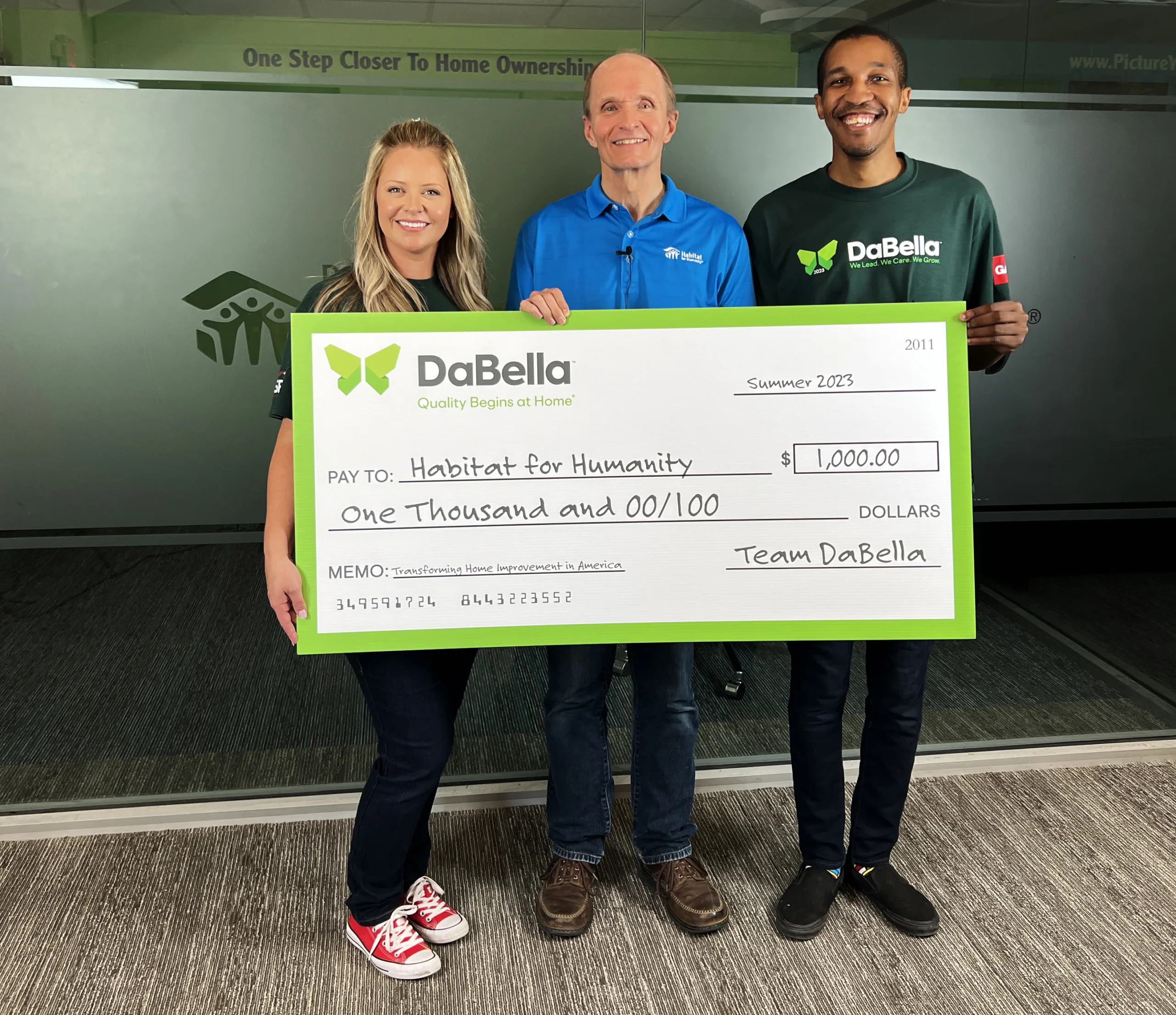 DaBella holding check to give to habitat for Humanity Dallas