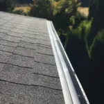 Premier gutters and gutter covers attached to an Asphalt shingle roof.