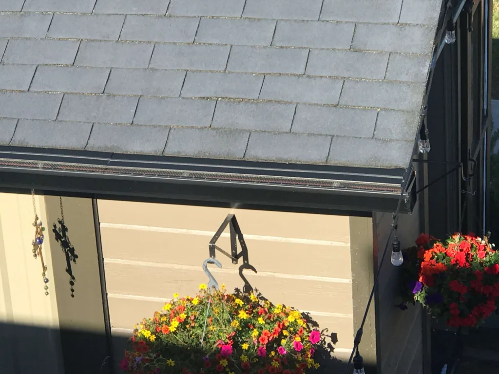 Premier Gutters and gutter covers with flowers in hanging baskets