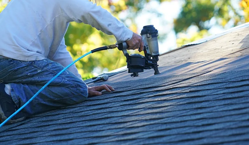 Roof Installer using a Nail Gun