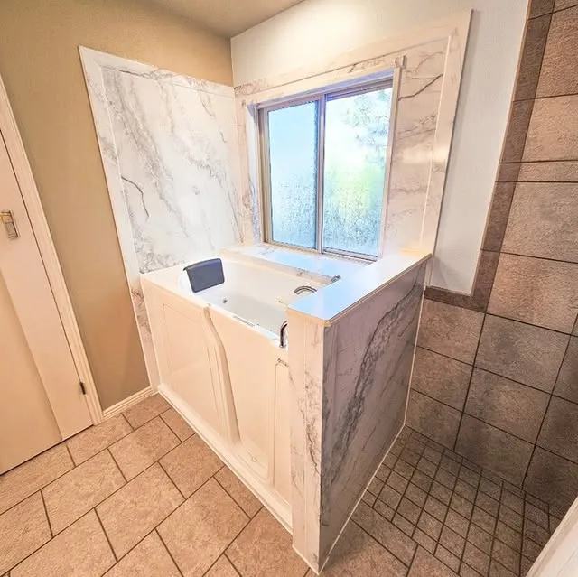 Walk-in Bathtub with window above it.