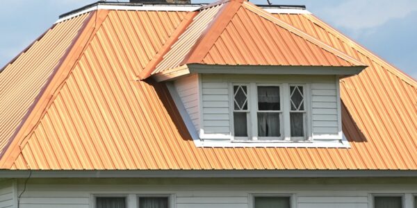 Home With a Copper Roof and White Siding